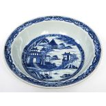 A CHINESE BLUE AND WHITE BASIN BOWL, 
18th century, decorated with dwellings in a landscape,