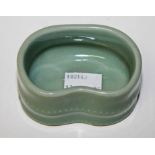 A KIDNEY SHAPED CELADON GROUND CHINESE PORCELAIN INK POT, 
3.25in (8.5cm).