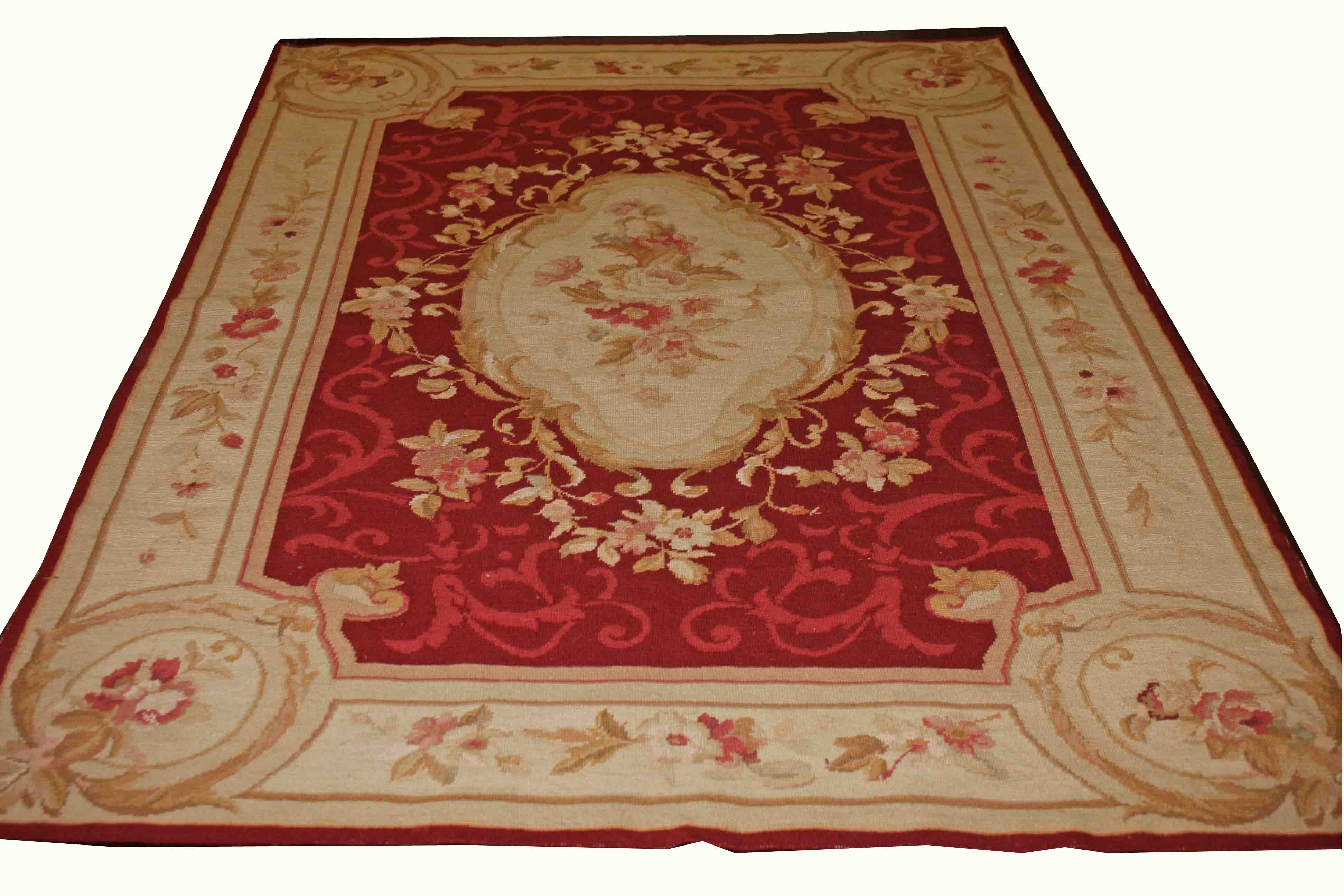 AN AUBUSSON STYLE PETIT POINT RUG OR WALL HANGING, 
with centre ivory floral medallion,