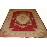 AN AUBUSSON STYLE PETIT POINT RUG OR WALL HANGING, 
with centre ivory floral medallion,