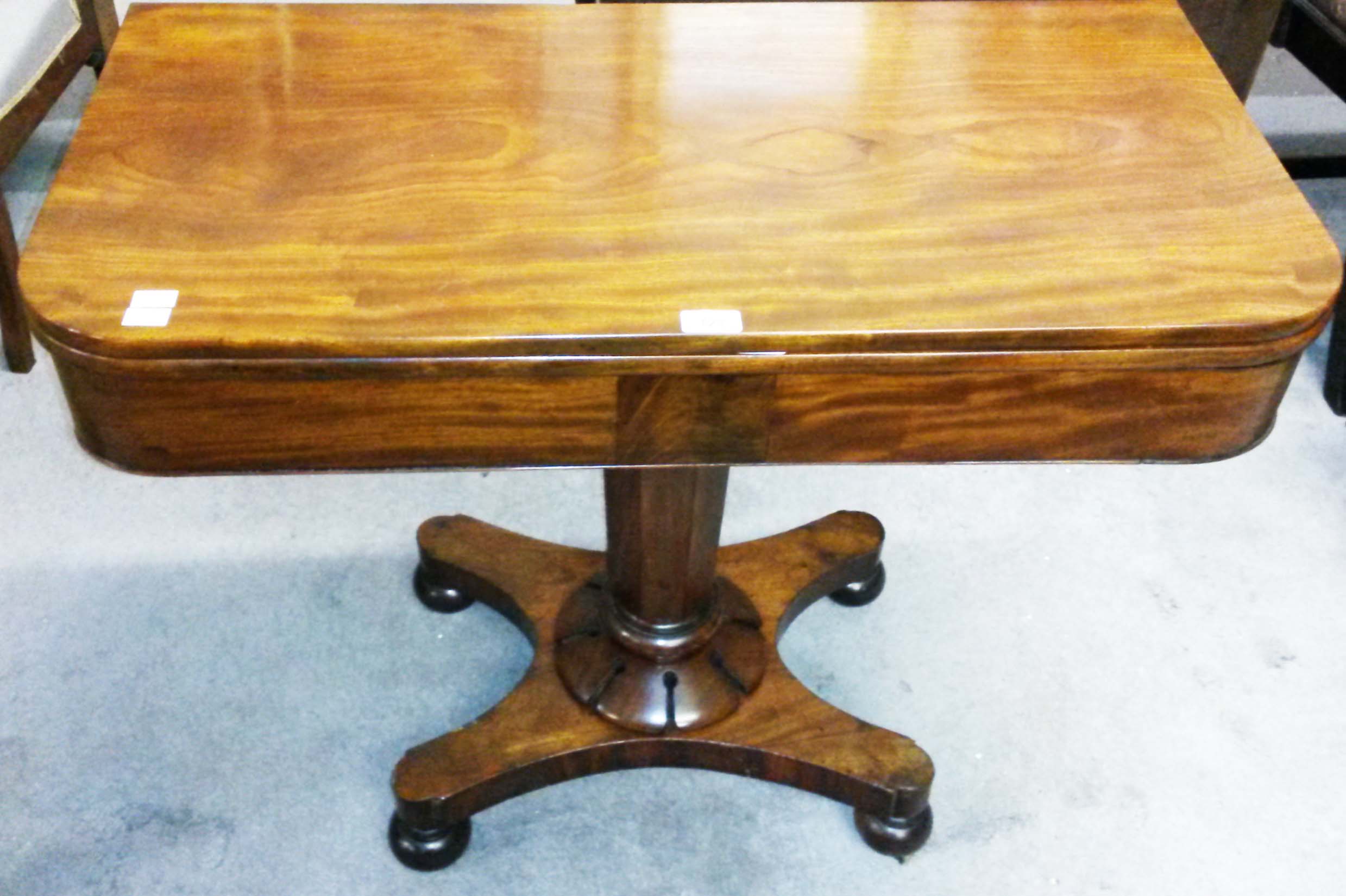 AN EARLY VICTORIAN MAHOGANY TEA TABLE, 
the top with rounded corners, above a plain frieze,