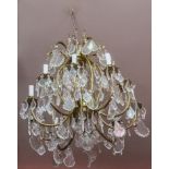 A TEN-BRANCH BRASS AND GLASS CHANDELIER, 
with baluster shaped centre, issuing ten candle arms,