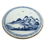 A CIRCULAR CHINESE PORCELAIN PANEL, 
decorated with figures and donkey in a mountainous landscape,