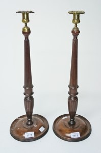 A PAIR OF MAHOGANY BRASS MOUNTED CANDLESTICKS, 
in the Georgian style,