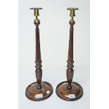 A PAIR OF MAHOGANY BRASS MOUNTED CANDLESTICKS, 
in the Georgian style,