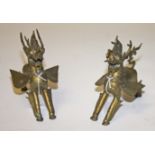 A PAIR OF INDIAN BRASS MODELS OF WINGED MYTHICAL ANIMALS, 
with green glass eyes, 8in (20cm).