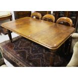 A LATE VICTORIAN TELESCOPIC MAHOGANY DINING TABLE, 
the moulded top with spare leaf,