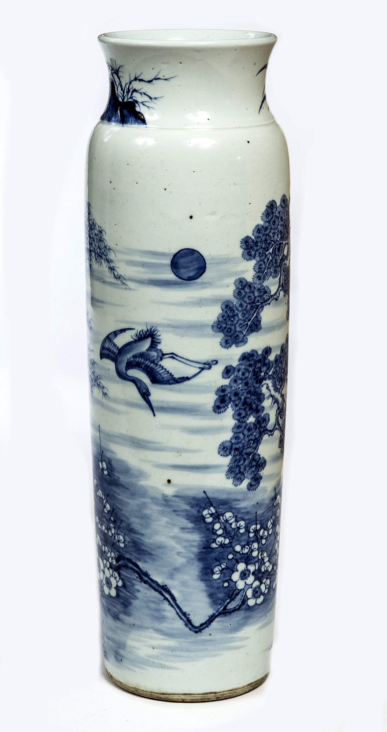 A TALL CHINESE BLUE AND WHITE VASE, 
decorated with lotus trees, bamboo, and a crane in flight, 18.
