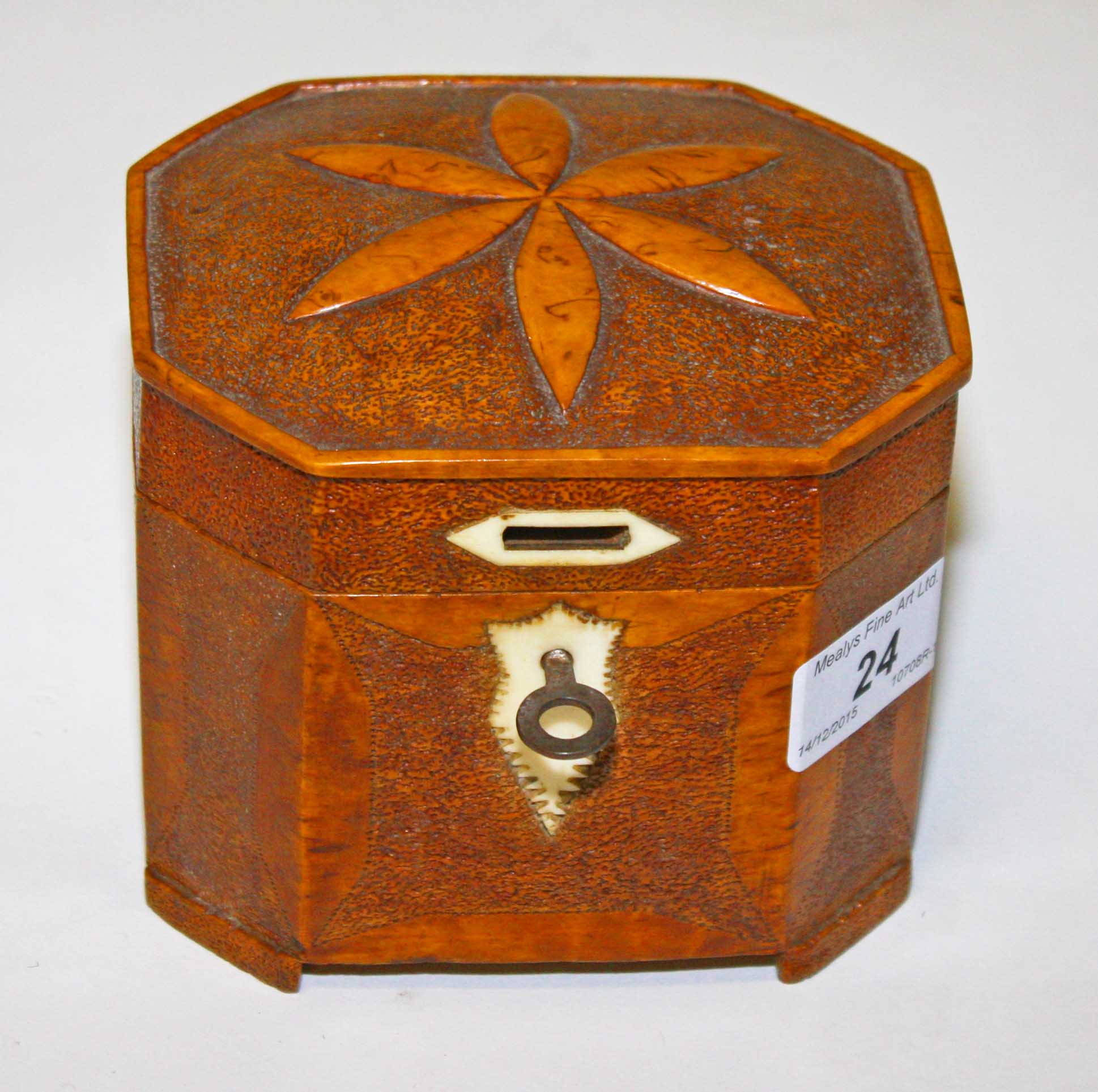 AN OCTAGONAL POKER-WORK TEA CADDY, 
with ivory mounts, 20th century 5in (13cm).