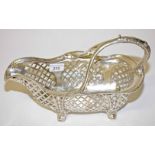 A PIERCED AND SILVER PLATED BASKET SHAPED TABLE TOP WINE BOTTLE STAND,