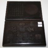 A RECTANGULAR CHINESE CARVED INK STONE, 
with calligraphy, in ditted wooden case, 10in (26cm).