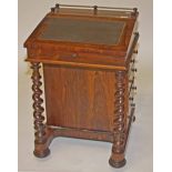 A VICTORIAN ROSEWOOD DAVENPORT, 
with three quarter brass gallery and a slope front writing surface,