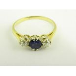 A SAPPHIRE AND DIAMOND THREE STONE RING IN 18CT GOLD, MARKS RUBBED, 2.2G