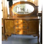 A MAHOGANY BOW FRONT SIDEBOARD WITH OVAL MIRROR BACK, EARLY 20TH C