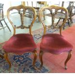 A PAIR OF VICTORIAN CARVED WALNUT DINING CHAIRS