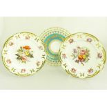 A PAIR OF COALPORT DESSERT PLATES MOULDED IN SEVRES STYLE AND GILT WITH C SCROLLS, PAINTED WITH