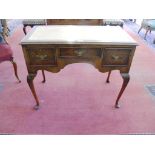 A WALNUT WRITING TABLE IN FORM OF A GEORGE I WALNUT LOWBOY BY WARING & GILLOW LTD, MAKER'S METAL