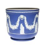 A WEDGWOOD JASPER WARE JARDINIERE dipped in blue jasper and ornamented with muses, 23cm h, impressed