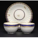 TWO DERBY BLUE AND GILT TEA BOWLS AND A SAUCER puce mark, saucer 13.5cm diam, 1786++ Saucer cracked,