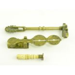 A VICTORIAN BRASS PASTRY JIGGER AND MOULD, A GILT BRASS SOVEREIGN BALANCE AND A MINIATURE BONE