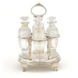 A GEORGE III CRUET the four bottle frame supported by pilasters and with oval ring handle, on