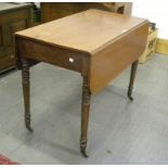 A VICTORIAN MAHOGANY PEMBROKE TABLE ON TURNED LEGS WITH BRASS CASTORS