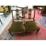 A PAIR OF LATE VICTORIAN CARVED WALNUT NURSING CHAIRS