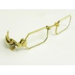 A FRENCH GOLD LORGNETTE WITH OCTAGONAL FRAMES AND DIAMOND SET DOUBLE LEAF CLIP HANDLE