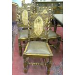 A SET OF FOUR CHARLES II STYLE CARVED OAK DINING CHAIRS WITH CANED SPLAT