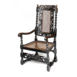 A JAMES II WALNUT AND CANED ELBOW CHAIR, C1685-90 with carved 'Boyes & Crownes' crest and forerails,
