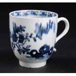 A LOWESTOFT BLUE AND WHITE COFFEE CUP, C1775  painted with Chinese flowers growing from a hollow
