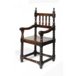 A CHARLES II OAK AND FRUITWOOD ARMCHAIR, C1680 with spindle back and bobbin turned legs and