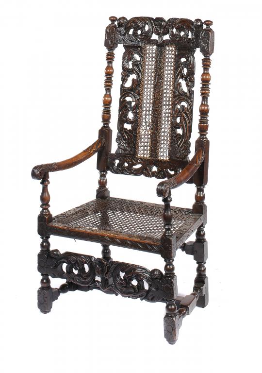 A CHARLES II WALNUT AND CANED ELBOW CHAIR, C1680-90 with a tulip to the crest and forerails, 118cm