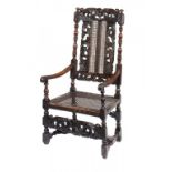 A CHARLES II WALNUT AND CANED ELBOW CHAIR, C1680-90 with a tulip to the crest and forerails, 118cm