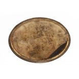 A  CONTINENTAL SILVER OVAL SALVER  on four feet, the underside engraved with contemporary