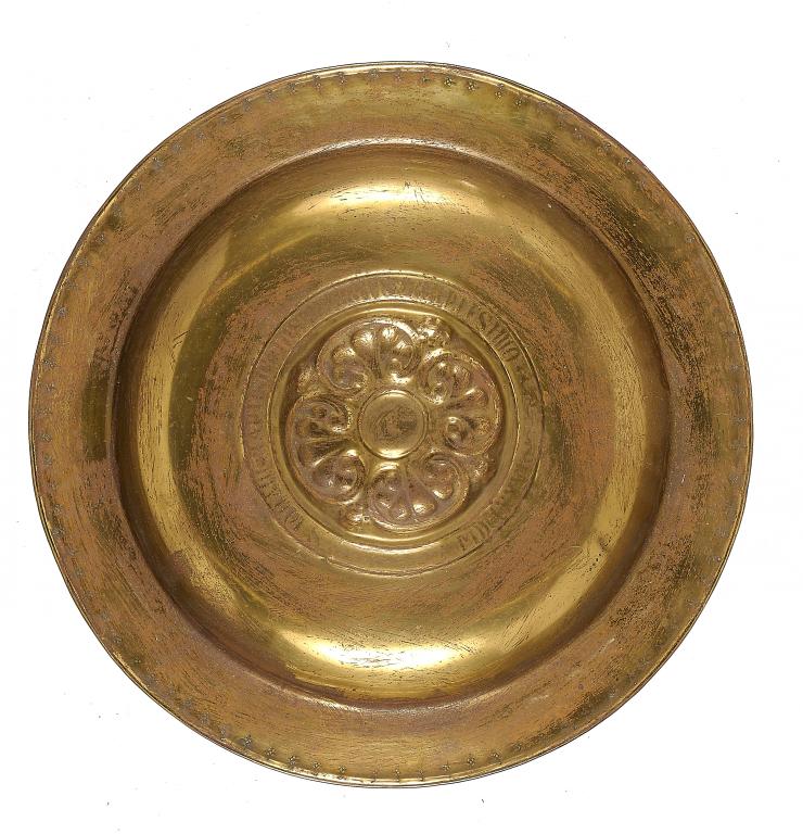 A NUREMBERG BRASS ALMS DISH, DATED 1676  circumscribed around the boss  S JOHNANI BAPTISTE