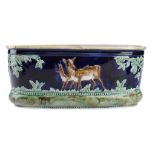 AN ENGLISH MAJOLICA JARDINIERE, C 1870  moulded to either side with a deer and faun, the interior