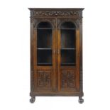 A NORTHERN EUROPEAN CARVED OAK BOOKCASE, LATE 19TH C  fitted with adjustable shelves, the sides also