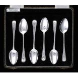 A COMPOSED SET OF SIX GEORGE III SILVER TEASPOONS  bright cut Old English pattern, crested, all