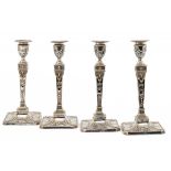 A SET OF FOUR VICTORIAN SILVER NEO CLASSICAL STYLE CANDLESTICKS with nozzles, 30cm h, by Martin,