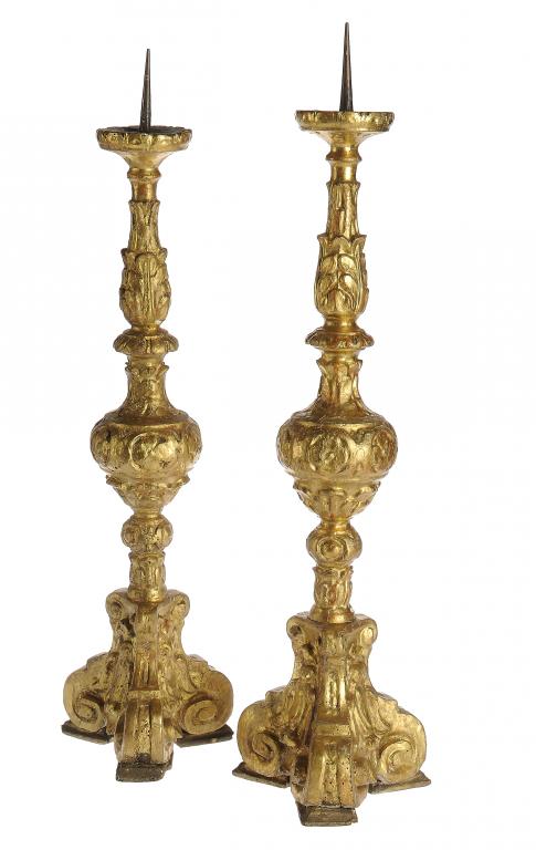 TWO MATCHING ITALIAN GILTWOOD ALTER CANDLESTICKS, 17TH C  the swollen centre knop carved with