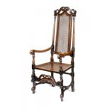 A QUEEN ANNE WALNUT AND CANED ELBOW CHAIR, C1710-20  136cm h++Old sheet metal repair at back of