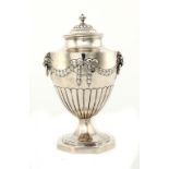 A GEORGE III SILVER NEO CLASSICAL STYLE VASE SHAPED TEA CADDY AND COVER  with lion mask handles,