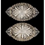 A PAIR OF VICTORIAN SILVER EMBOSSED SWEETMEAT DISHES  with cast openwork handles, 25cm w, by