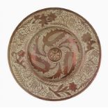 AN HISPANO MORESQUE STYLE COPPER LUSTRE DISH,  C1900 with central moulded rosette and four flowers