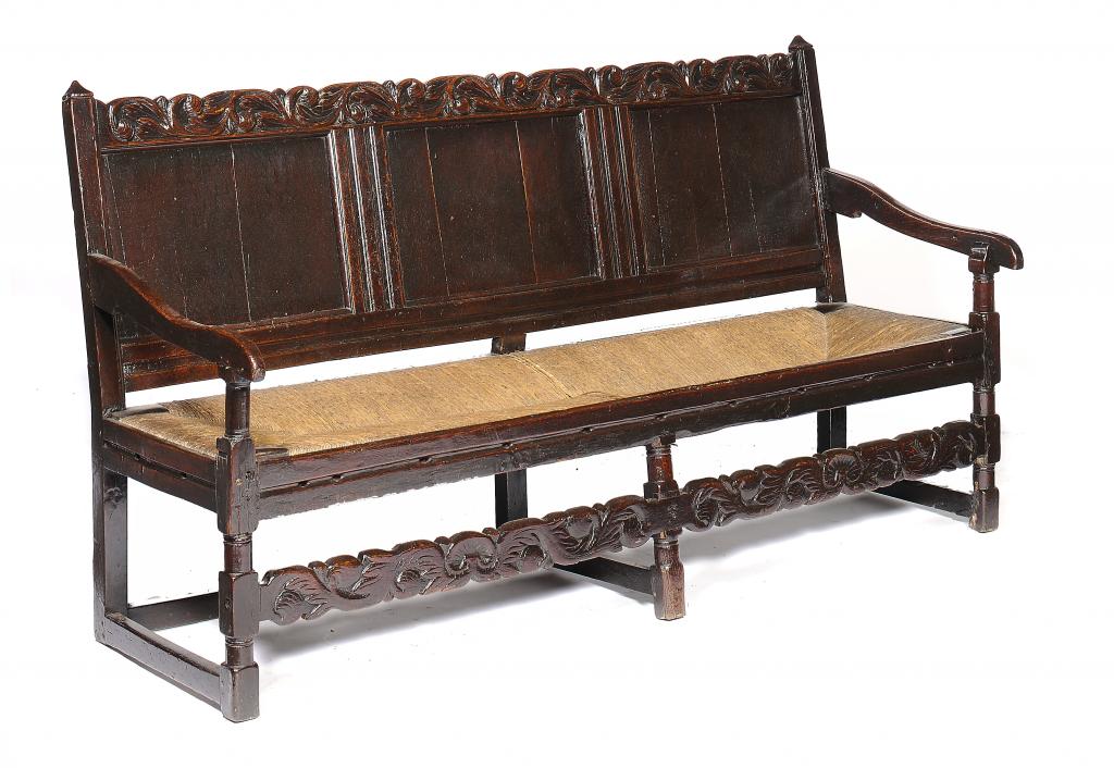 A CHARLES II OAK SETTLE, LATE 17TH the back with flared finials, 99cm h, 182cm w++Long with the