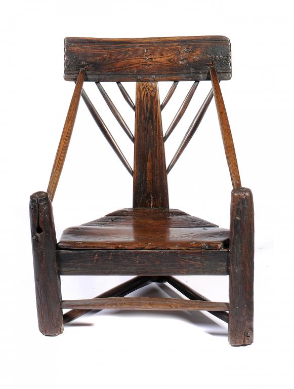 A RARE CHARLES I PRIMITIVE TRIANGULAR ARMCHAIR,  C1630  of ,possibly, chestnut, 76cm hA similar