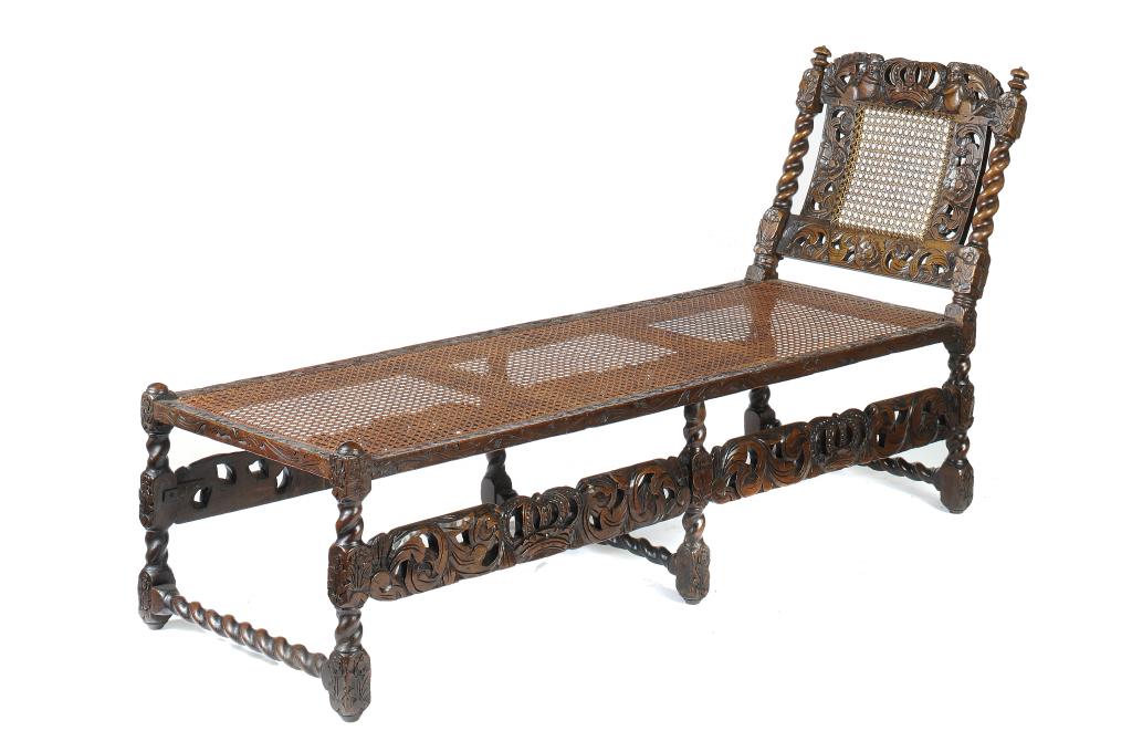 A CHARLES II WALNUT AND CANED DAYBED, C1685-90  with carved 'Boyes & Crownes' crest rail, 85cm h; 56