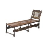 A CHARLES II WALNUT AND CANED DAYBED, C1685-90  with carved 'Boyes & Crownes' crest rail, 85cm h; 56