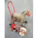 A FELT AND METAL PULL ALONG BELL TOY AND FELT AND RED PAINTED METAL PUSH ALONG PONY TOY